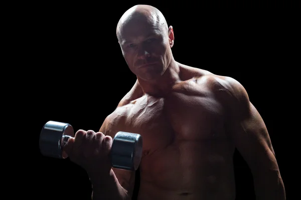 Portrait of bodybuilder exercising with dumbbell — Stock Photo, Image