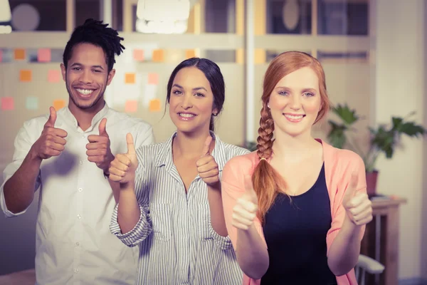 Business people showing thumbs up in office — Stock Photo, Image