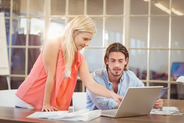 Empresaria explicando colega masculino en portátil — Foto de Stock