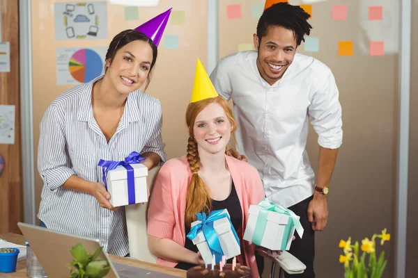 Portrait of happy colleagues holding gifts — Stock Photo, Image