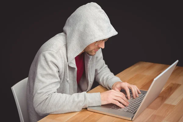 Businessman with hooded shirt working on laptop — Stock Photo, Image