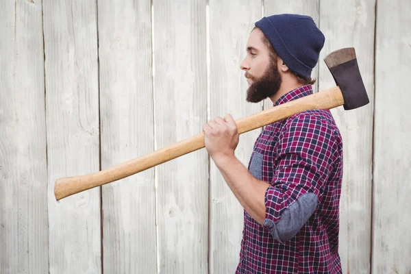 Side view of hipster with axe on shoulder — Stock Photo, Image