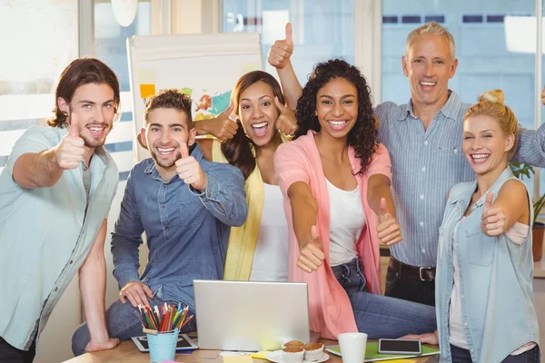 Happy business people showing thumbs up — Stock Photo, Image
