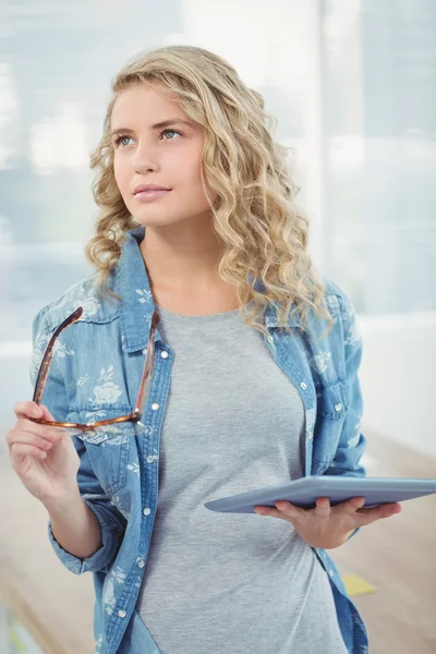 Woman holding eyeglasses and digital tablet — Stock Photo, Image