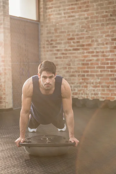 Man doing bosu push ups — Stock Photo, Image