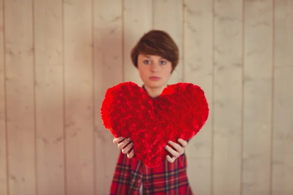 Bella donna che tiene un cuscino del cuore — Foto Stock