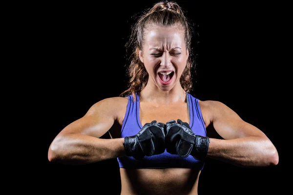 Aggressive female boxer flexing muscles — Stock Photo, Image