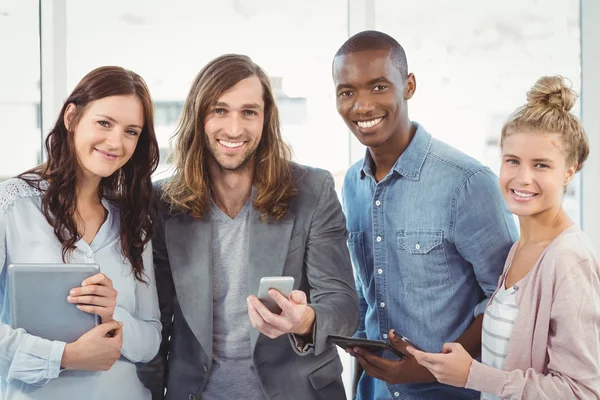 Portrait of smiling business team using technology — Stock Photo, Image
