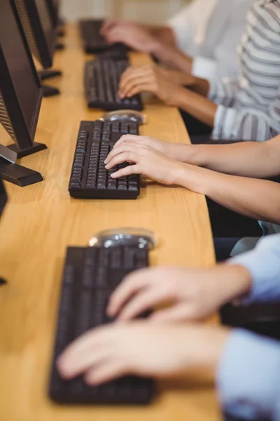 Mãos cortadas de executivos no teclado no escritório — Fotografia de Stock