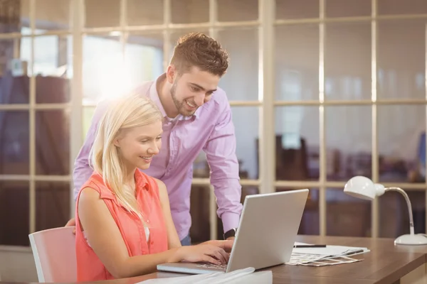 Smiling Business people looking at laptop — Stock Photo, Image