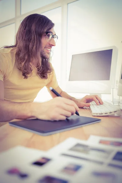 Hipster with graphics tablet typing on keyboard — Stock Photo, Image
