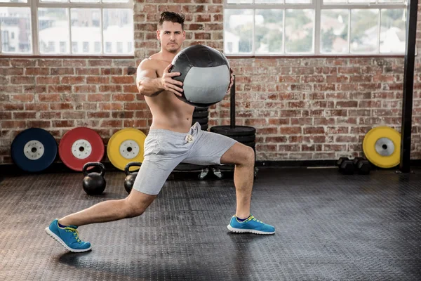 Porträt eines muskulösen Mannes, der mit Medizinball trainiert — Stockfoto