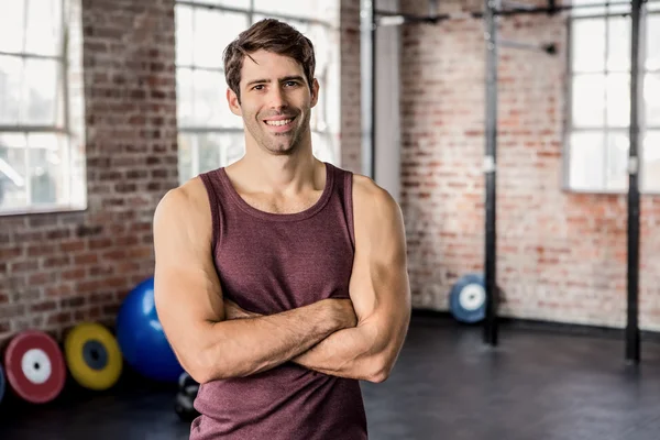 Portrait of man smiling with arms crossed — Stock Photo, Image