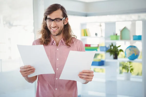 Happy hipster looking at documents — Stock Photo, Image