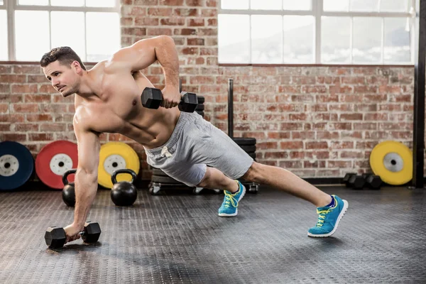 Shirtless man exercising with dumbbell — Stock Photo, Image