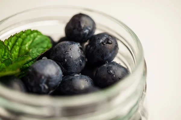 Glass jar of fresh blueberries — Stock Photo, Image