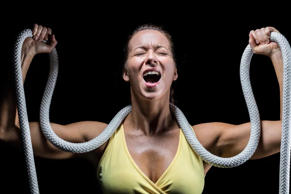 Angry woman holding rope around neck with arms raised — Stock Photo, Image