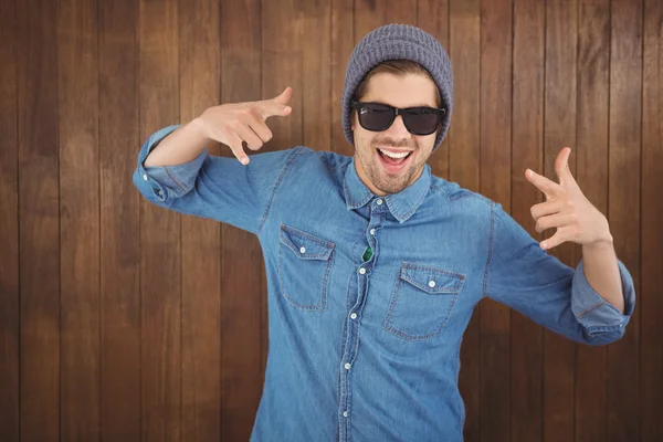 Happy hipster showing rock and roll hand sign — Stock Photo, Image