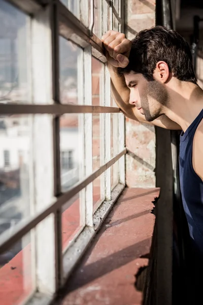 Handsome man looking outside window — Stock Photo, Image