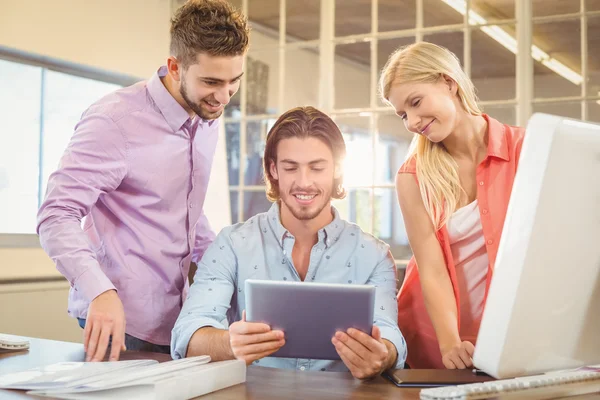 Happy business people looking at digital table — Stock Photo, Image