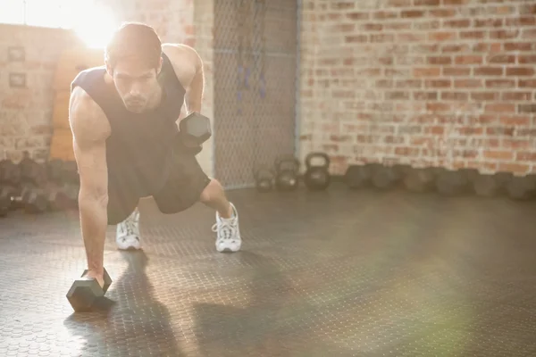 Focused man lifting dumbbell — Stock Photo, Image