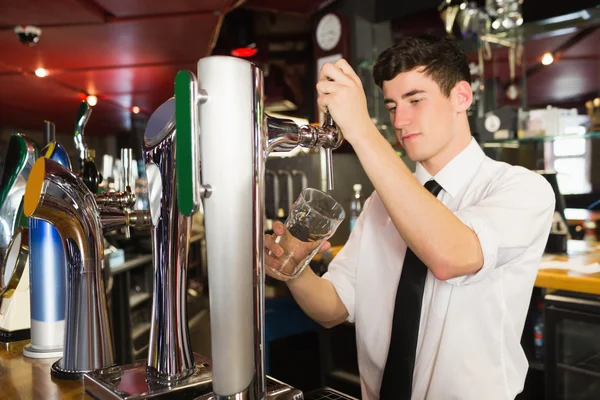 Bartender holding glass standing — Stock Photo, Image