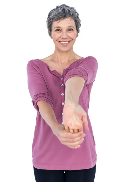 Portrait of happy mature woman stretching — Stock Photo, Image
