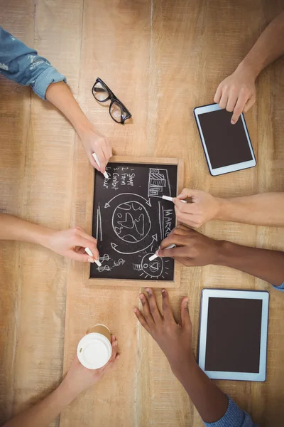 Close-up of cropped hands writing business terms — Stock Photo, Image