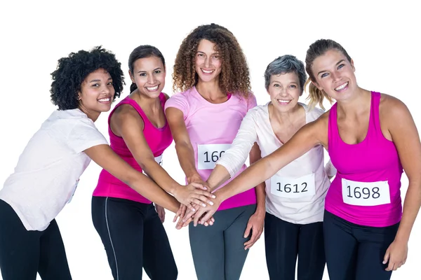 Portrait of smiling athletes putting their hands together — Stock Photo, Image