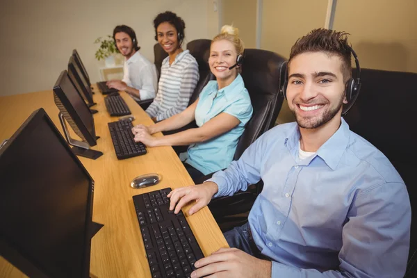 Portrait of smiling business people in call center — Stock Photo, Image