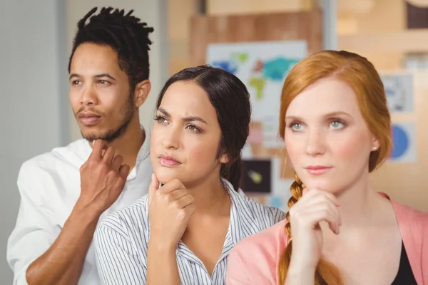 Thoughtful business people looking away at office — Stock Photo, Image
