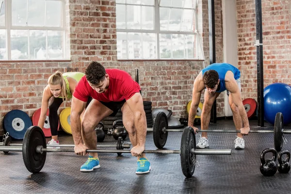 People lifting barbell — Stock Photo, Image