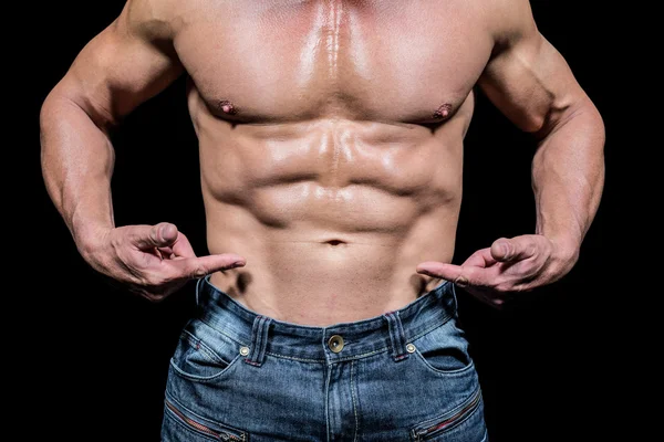 Midsection of shirtless man pointing at abs — Stock Photo, Image