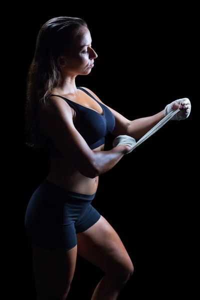 Confident boxer tying bandage on hand — Stock Photo, Image