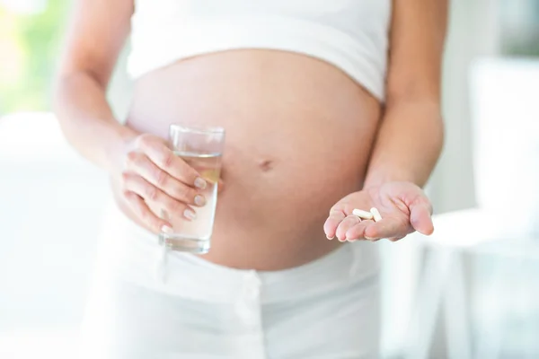 Midsection of woman with medication — Stock Photo, Image