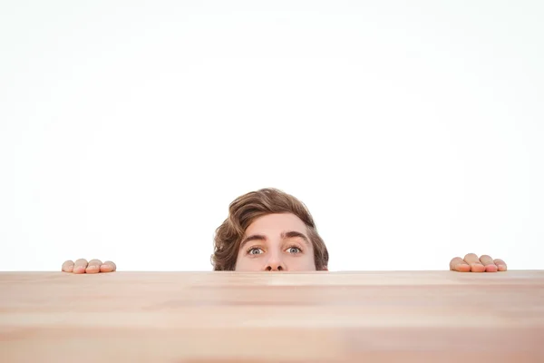Man gömmer sig bakom skrivbord — Stockfoto