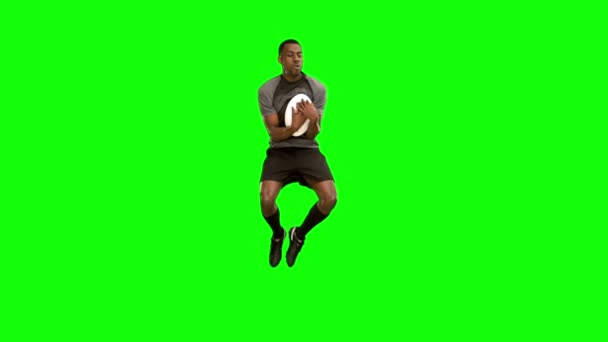 Serious rugby player catching ball — Stock Video