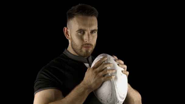 Serious rugby player holding ball — Stock Video