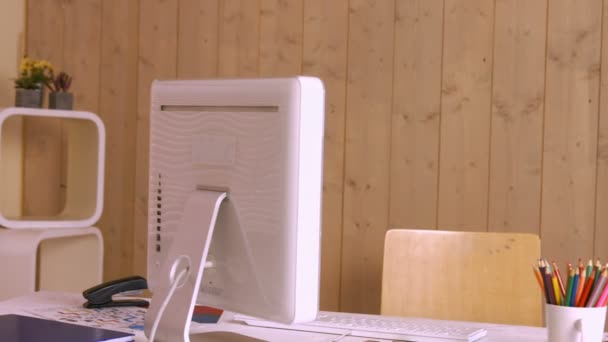 Desk with computer and colour pencils — Stock Video