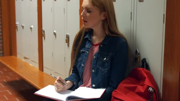 Studentin schreibt in ihr Schultagebuch — Stockvideo