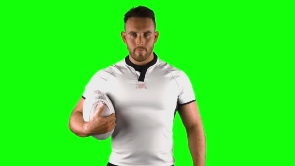 Serious rugby player holds rugby ball — Stock Video