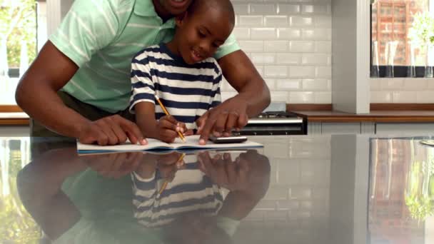 Padre ayudando a su hijo con la tarea — Vídeo de stock