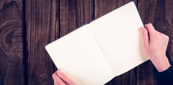 Overhead view of hand holding book — Stock Photo, Image