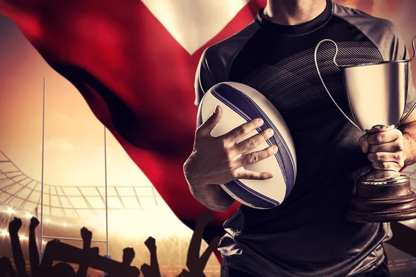 Composite image of midsection of successful rugby player holding — Stock Photo, Image