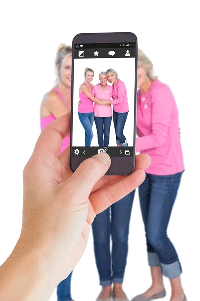 Imagem composta da mão feminina segurando um smartphone — Fotografia de Stock