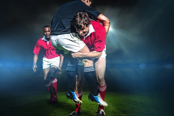 Rugby players tackling during game — Stock Photo, Image