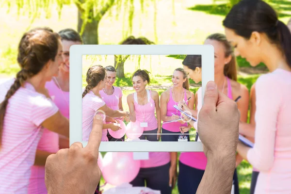 Composite image of hand holding tablet pc — Stock Photo, Image