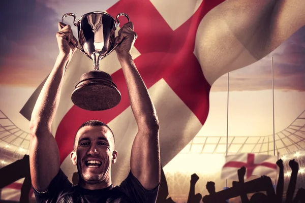 Portrait of successful rugby player holding trophy — Stock Photo, Image