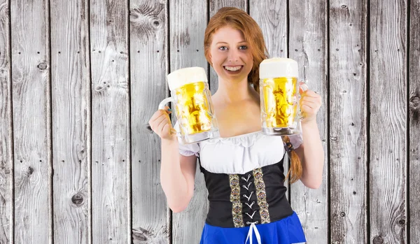 Oktoberfest girl holding jugs of beer — Stock Photo, Image