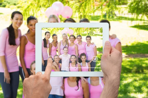 Composite image of hand holding tablet pc — Stock Photo, Image